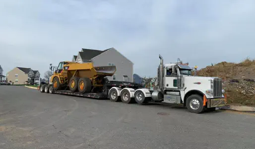 Stagecoach Mccloskey crushing plant being transported on a lowboy during winter
